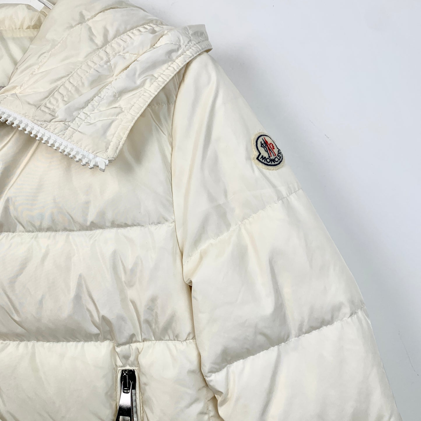 Moncler Nesea Series Off-White Hooded Down Jacket with Logo Patch and Ruffle Details