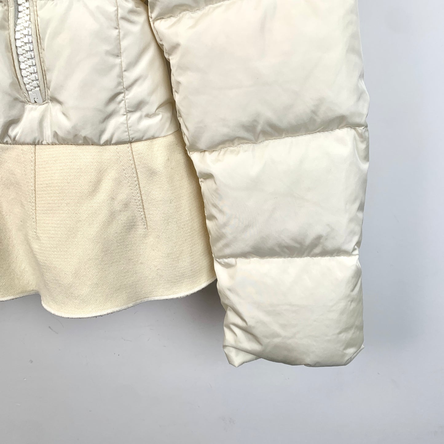 Moncler Nesea Series Off-White Hooded Down Jacket with Logo Patch and Ruffle Details